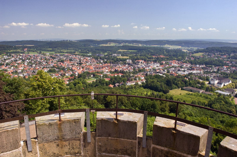 Schwarz-weißes Zimmertheater-Logo mit Porträts von Simon und Stefan und goldenen Akzenten.